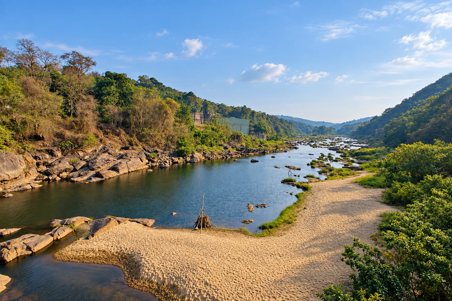 Rocky river valley and forested hills at Athikkayam