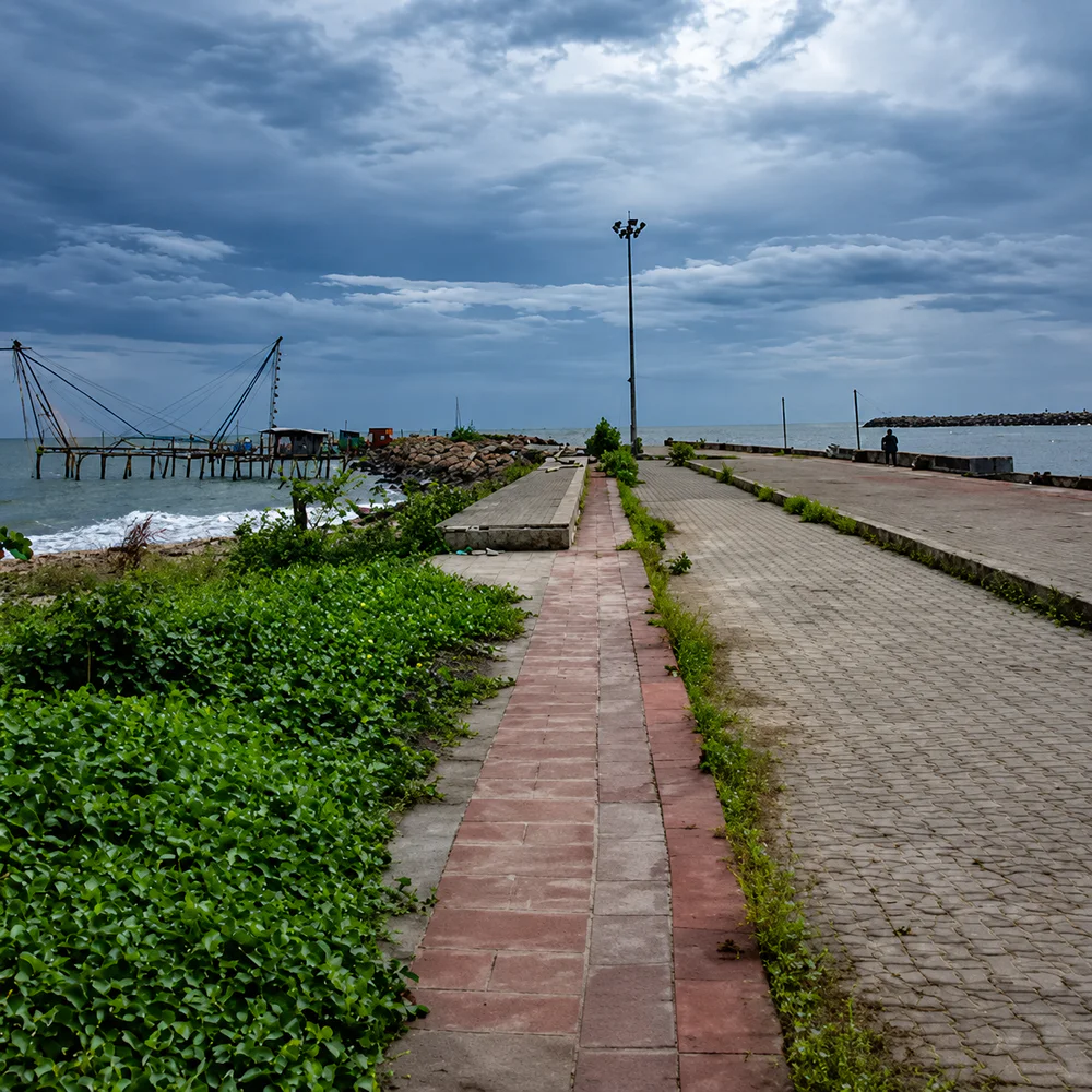 Coastal walkway and fishing-net shoreline at Munakkal Pulimuttu