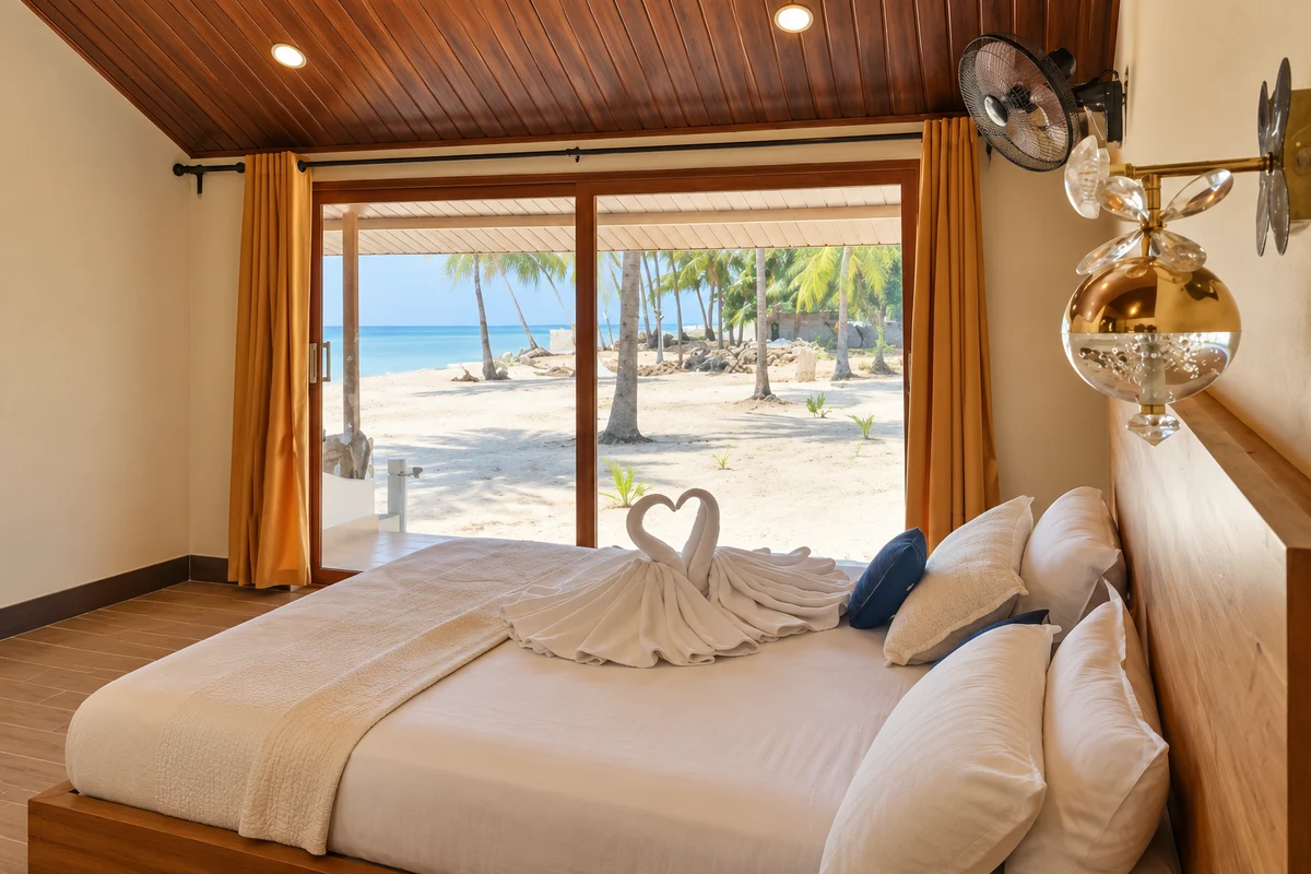 Supplied sea-view room photo expanded with AI to show the bed and large window overlooking palms and the sea